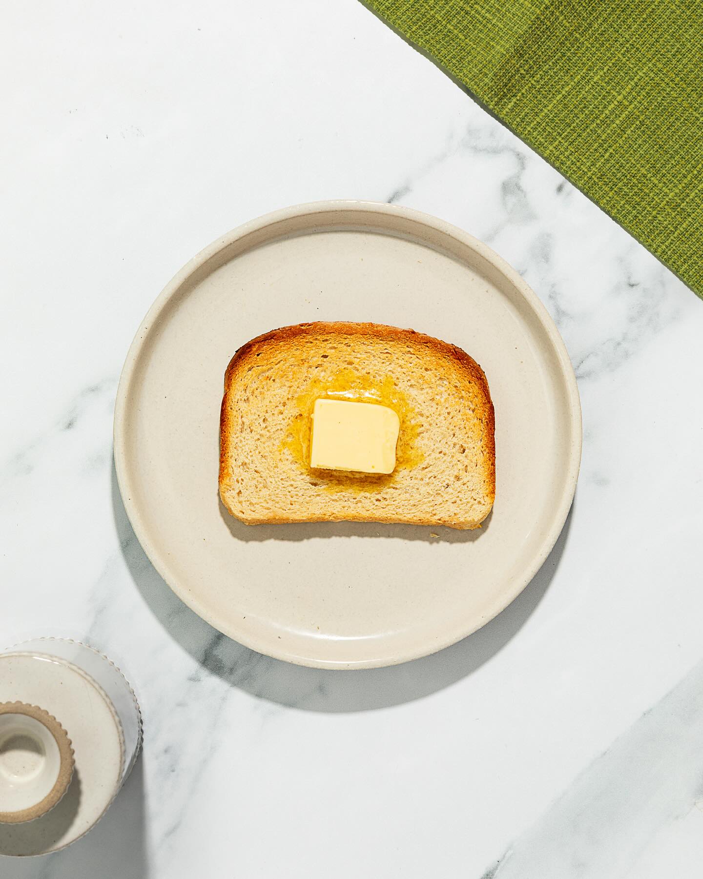 Simple pad of butter on toasted Rudi's bread