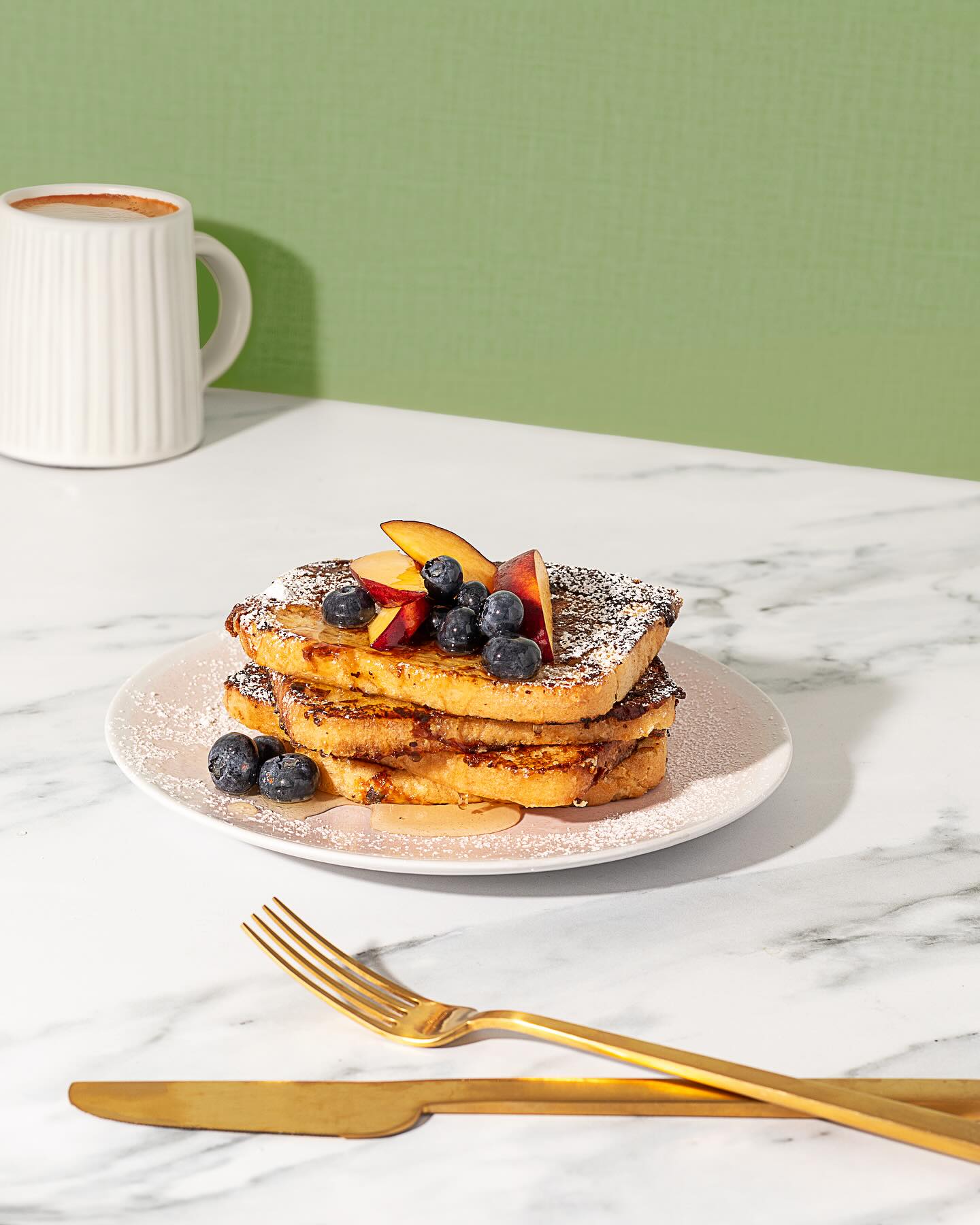 Yummy stack of french toast with fruit and berries
